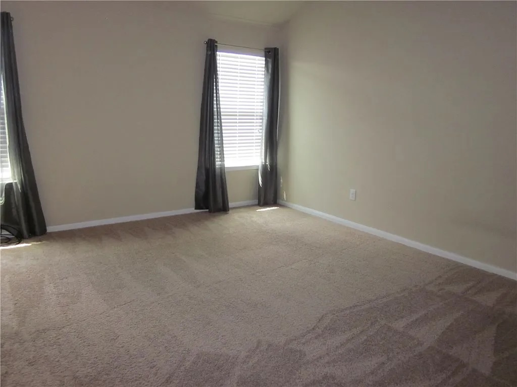 541 Alpha Kyle, TX 78640 - Photo 5 of 9 An inviting room awaits personal touches with soft carpeting and ample natural illumination.