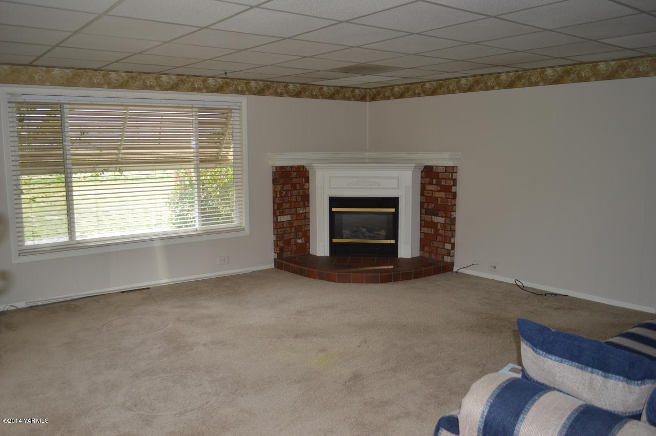 7007 Bell Road Yakima, WA 98901 - Photo 5 of 15 a view of an empty room with a fireplace and a window