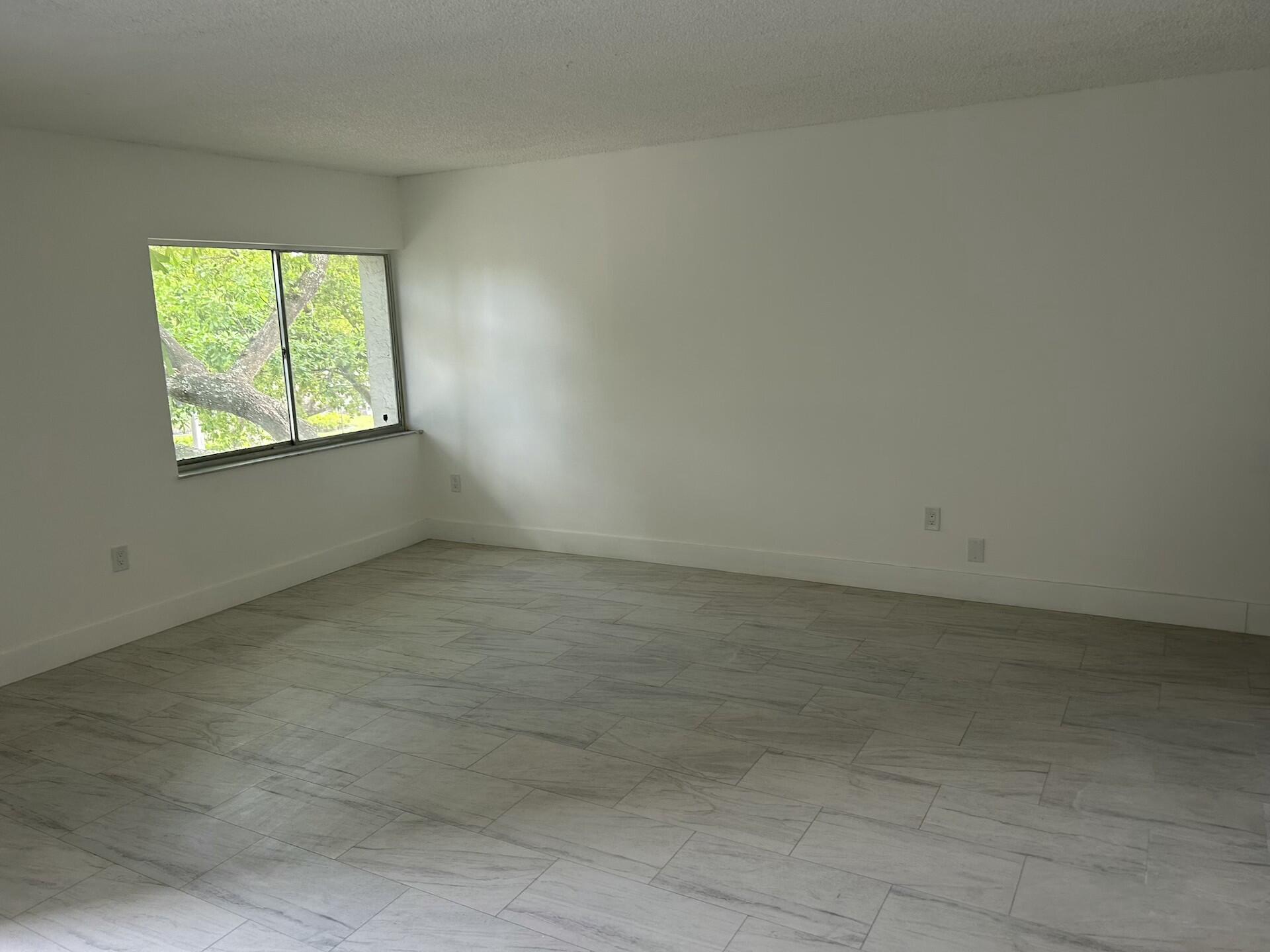 701 North Pine Island Road, Unit 304 Plantation, FL 33324 - Photo 13 of 77 an empty room with a window
