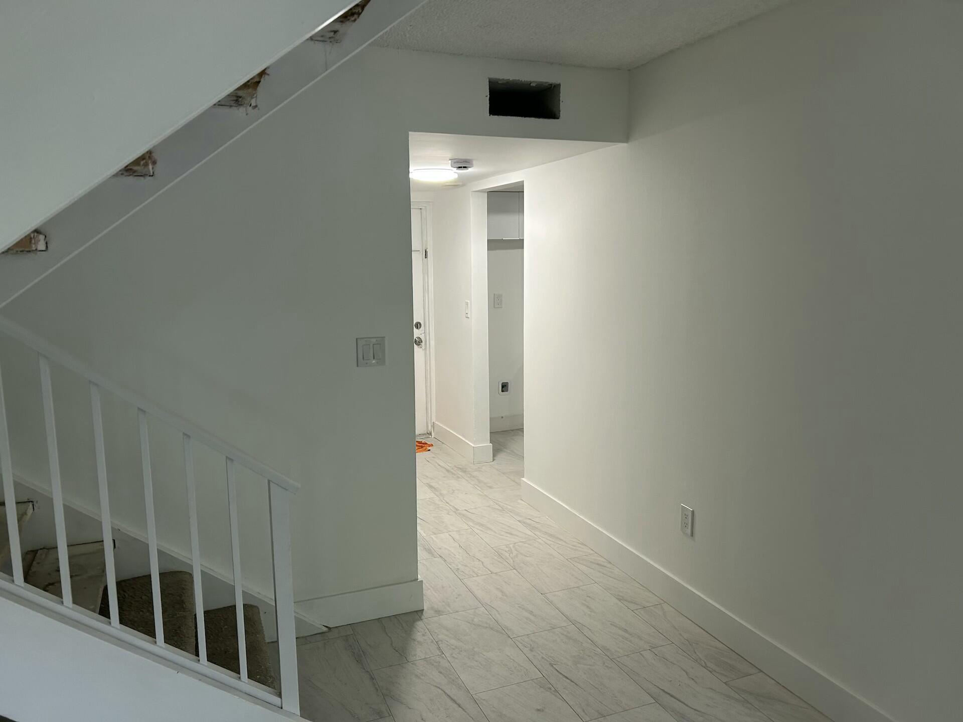 701 North Pine Island Road, Unit 304 Plantation, FL 33324 - Photo 17 of 77 a view of a hallway with wooden floor and a window