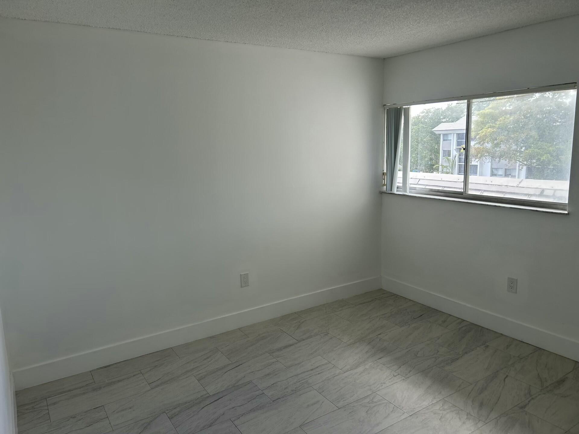 701 North Pine Island Road, Unit 304 Plantation, FL 33324 - Photo 19 of 77 an empty room with a window
