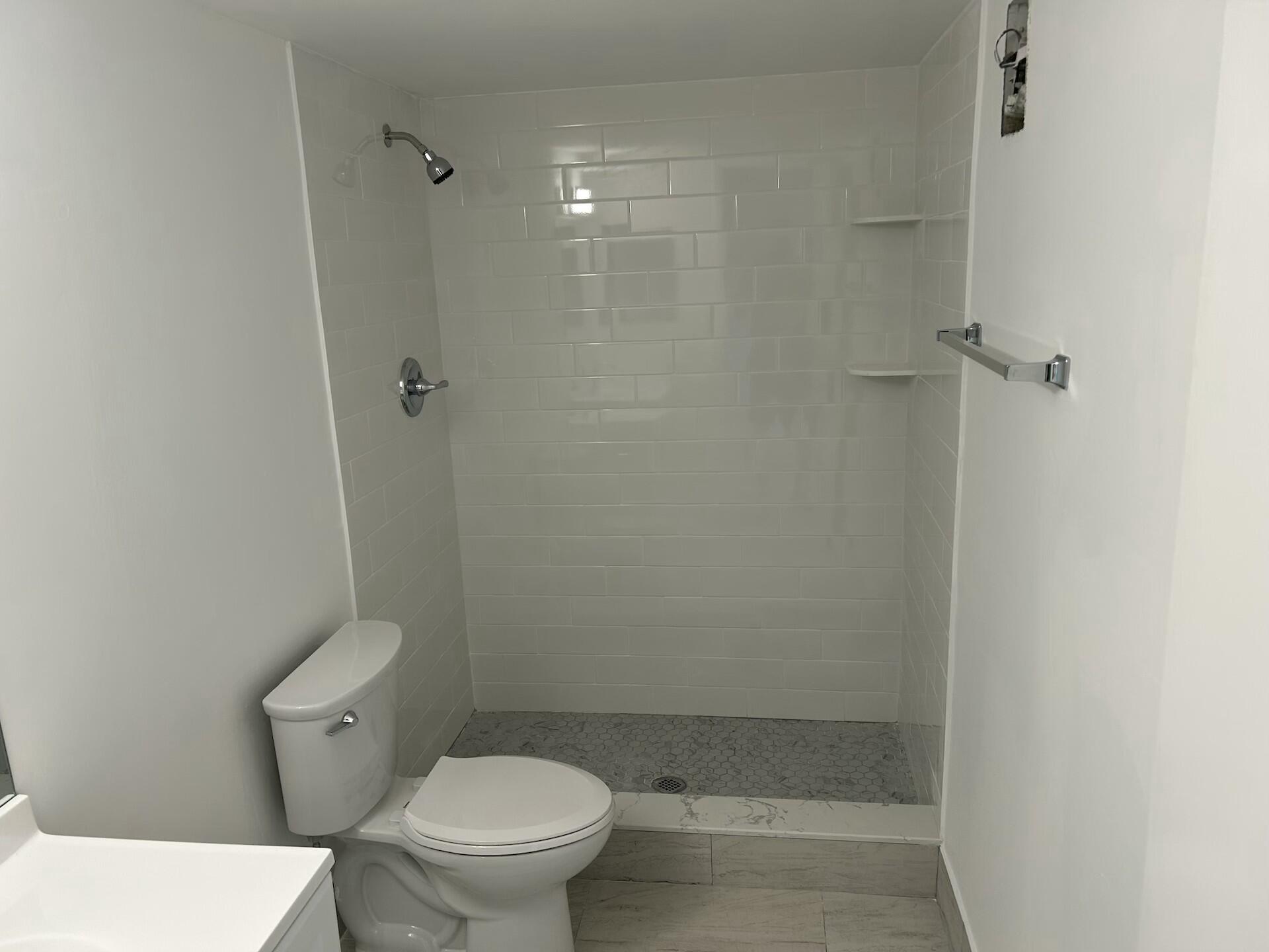701 North Pine Island Road, Unit 304 Plantation, FL 33324 - Photo 27 of 77 a bathroom with a toilet and a shower