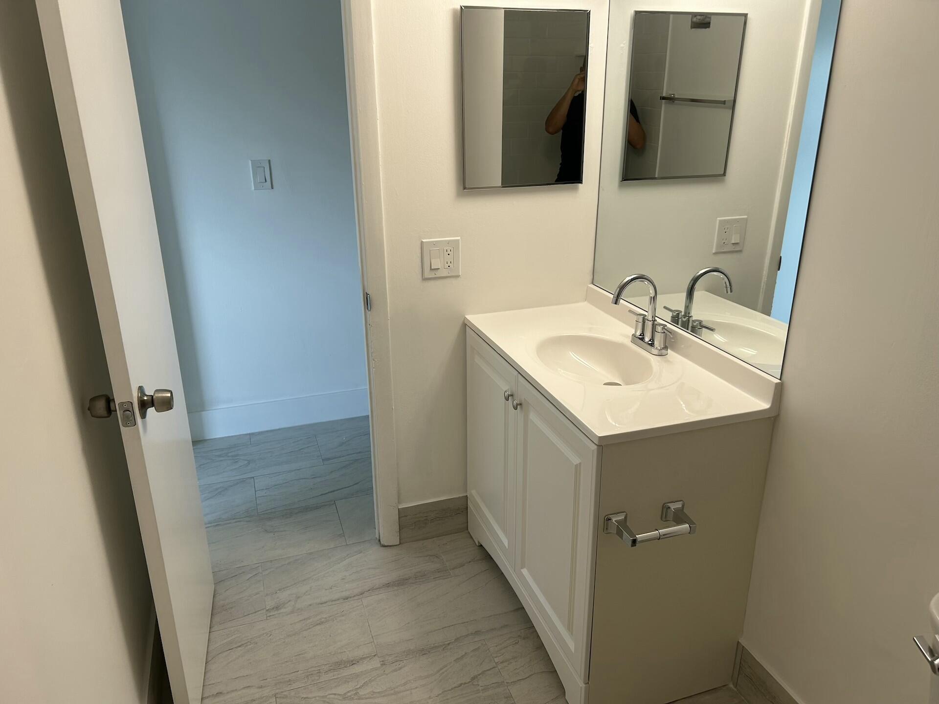 701 North Pine Island Road, Unit 304 Plantation, FL 33324 - Photo 29 of 77 a bathroom with a sink and mirror