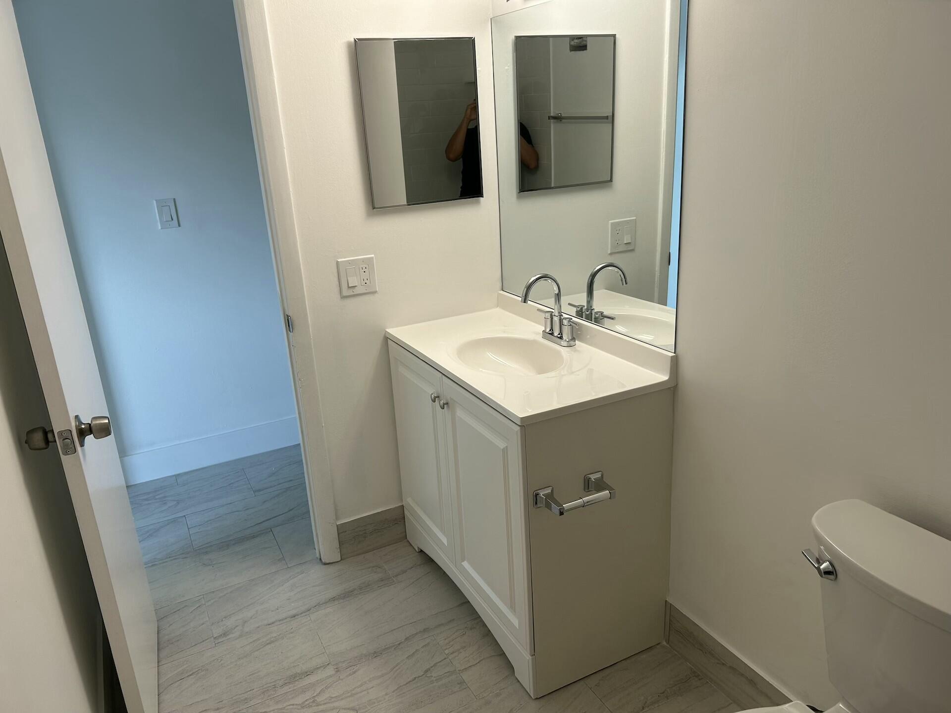 701 North Pine Island Road, Unit 304 Plantation, FL 33324 - Photo 30 of 77 a bathroom with a sink and mirror