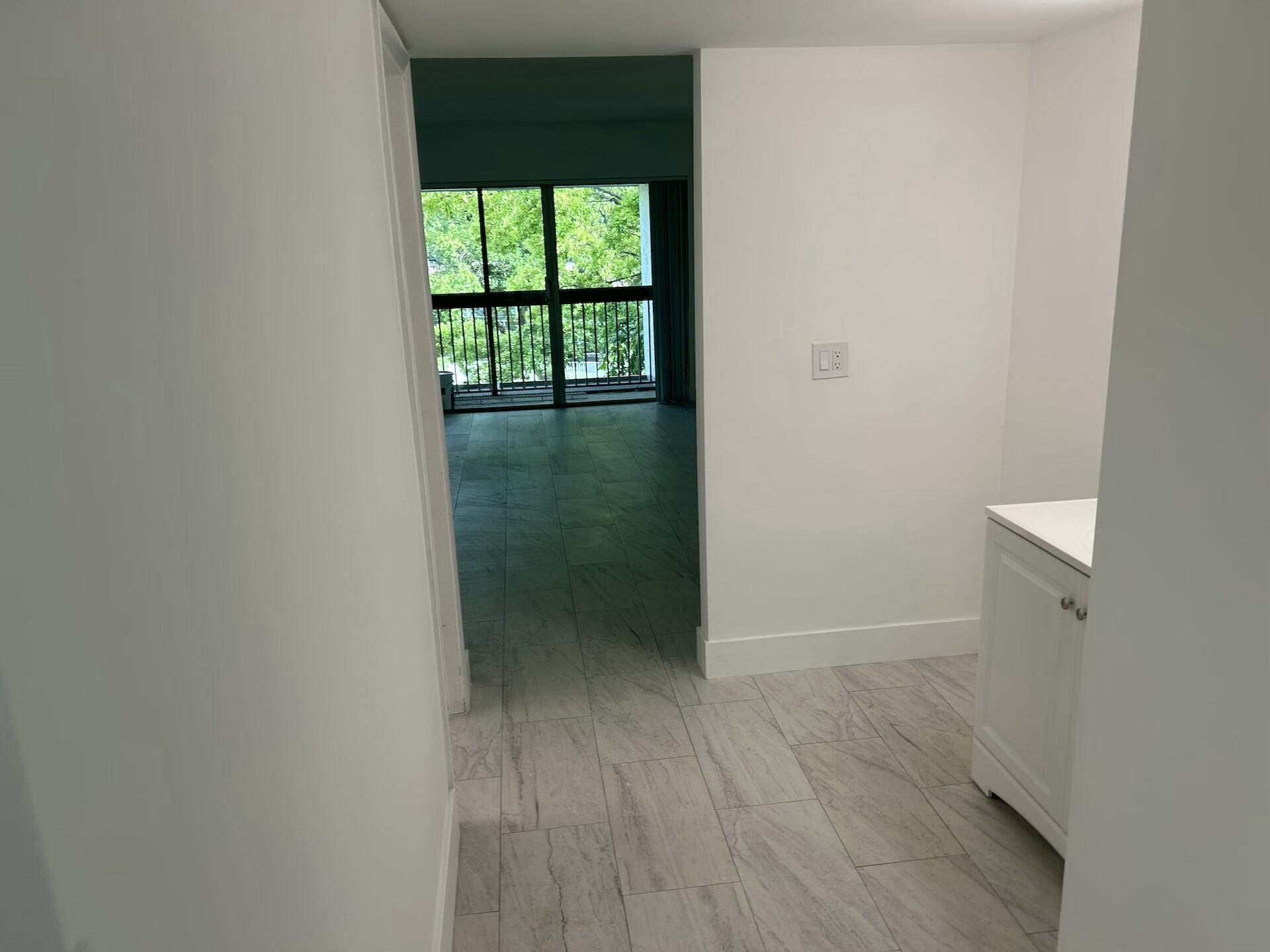 701 North Pine Island Road, Unit 304 Plantation, FL 33324 - Photo 38 of 77 a view of an empty room with wooden floor and fan