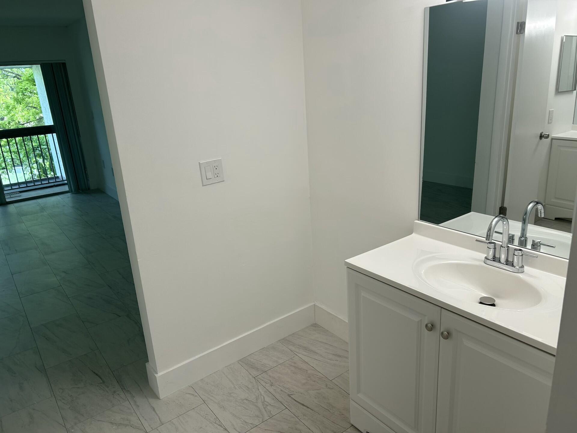 701 North Pine Island Road, Unit 304 Plantation, FL 33324 - Photo 39 of 77 a bathroom with a sink and a mirror