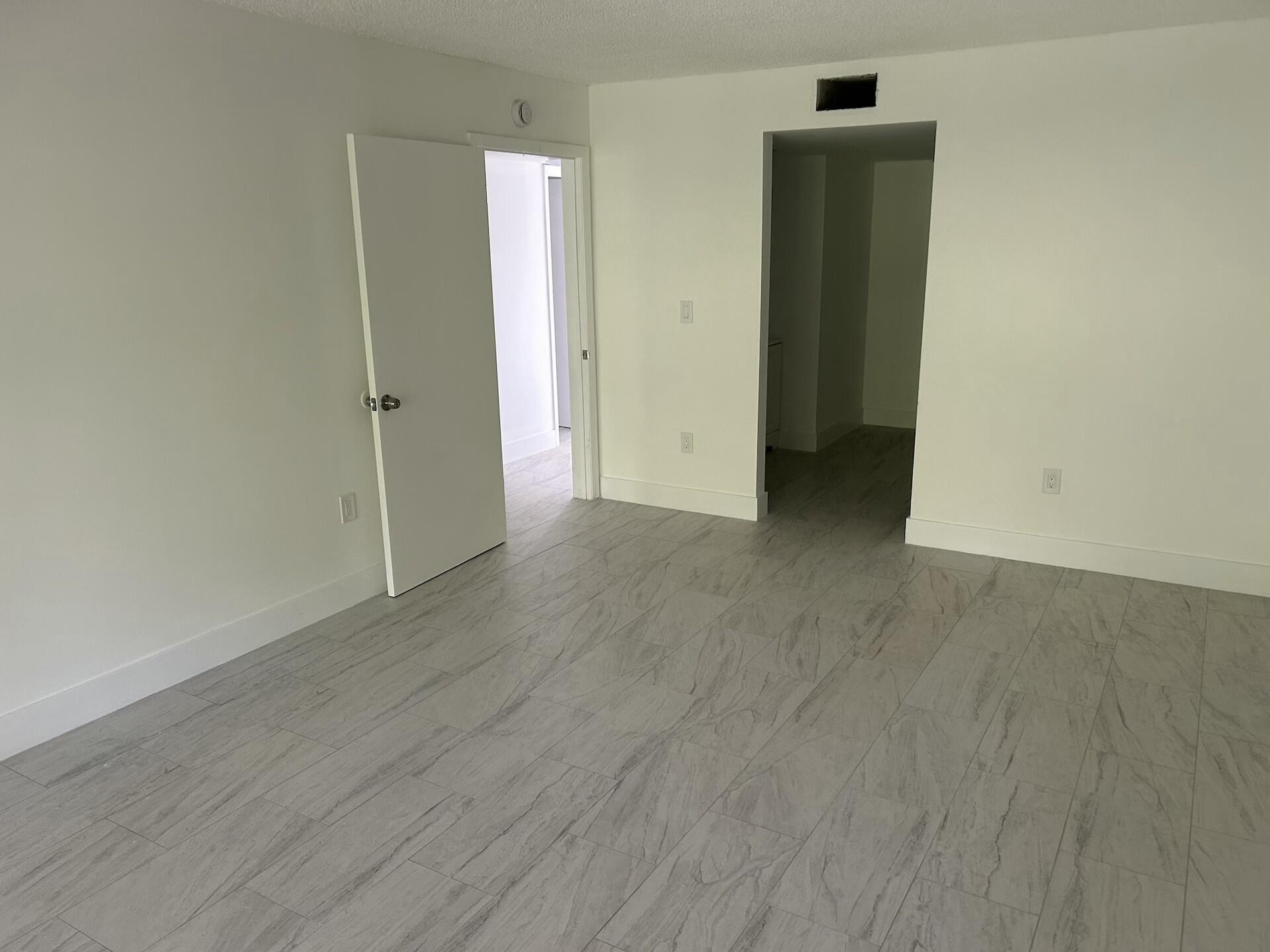 701 North Pine Island Road, Unit 304 Plantation, FL 33324 - Photo 47 of 77 an empty room with wooden floor and closet