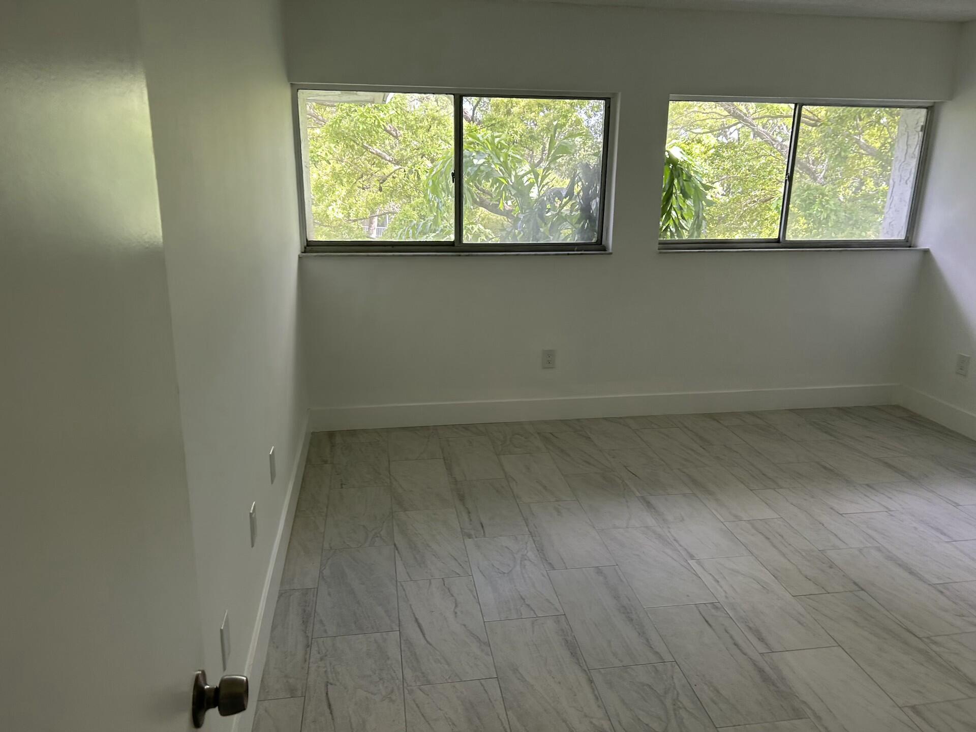 701 North Pine Island Road, Unit 304 Plantation, FL 33324 - Photo 50 of 77 an empty room with a window