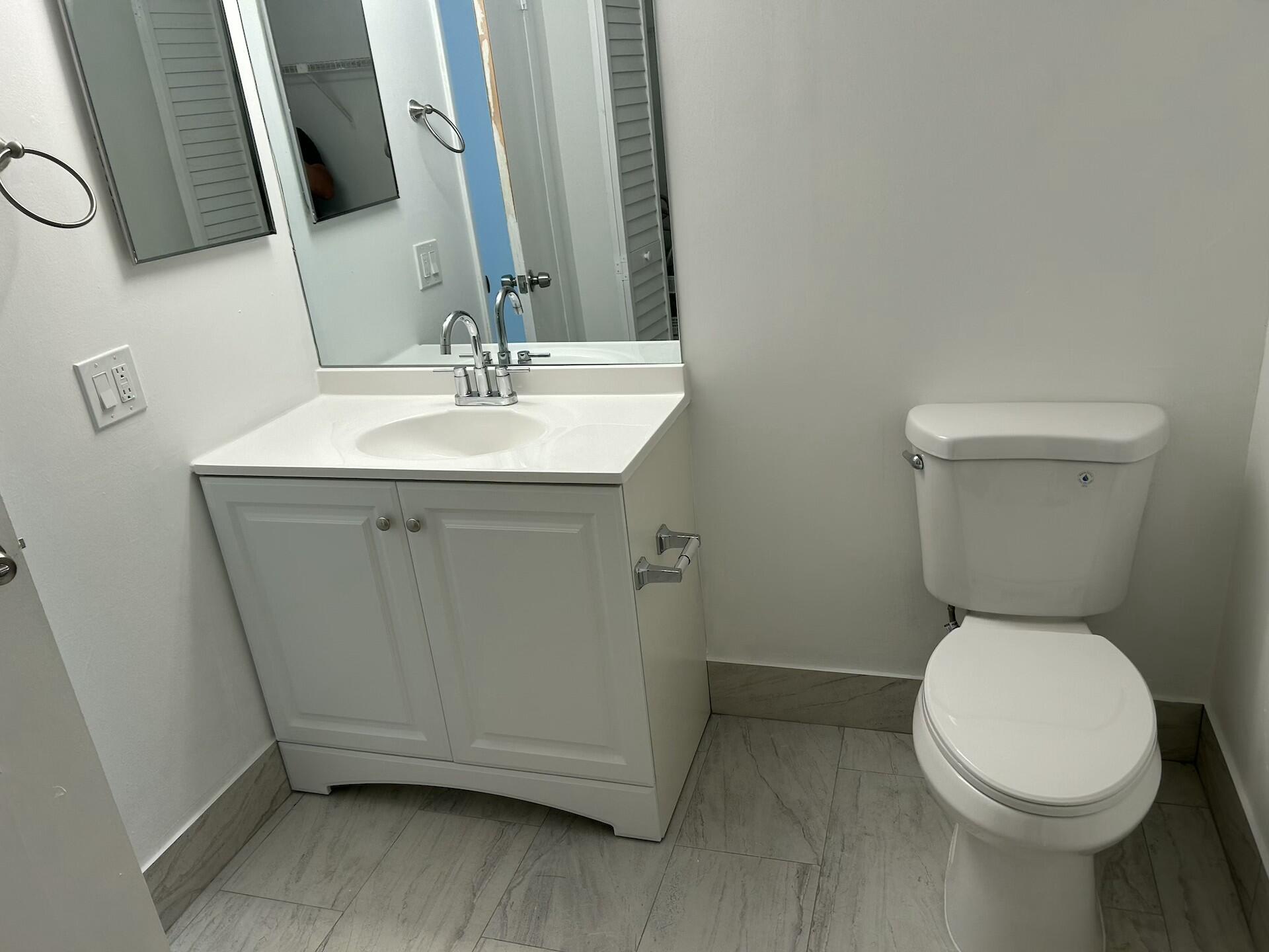 701 North Pine Island Road, Unit 304 Plantation, FL 33324 - Photo 61 of 77 a bathroom with a sink a toilet and a mirror