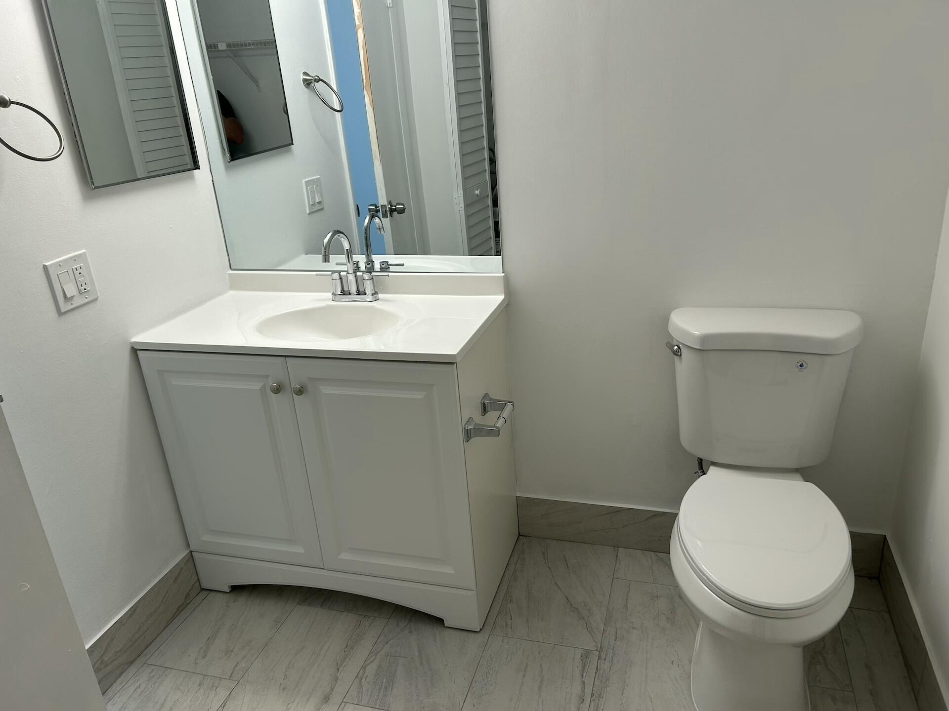 701 North Pine Island Road, Unit 304 Plantation, FL 33324 - Photo 62 of 77 a bathroom with a sink a toilet and mirror