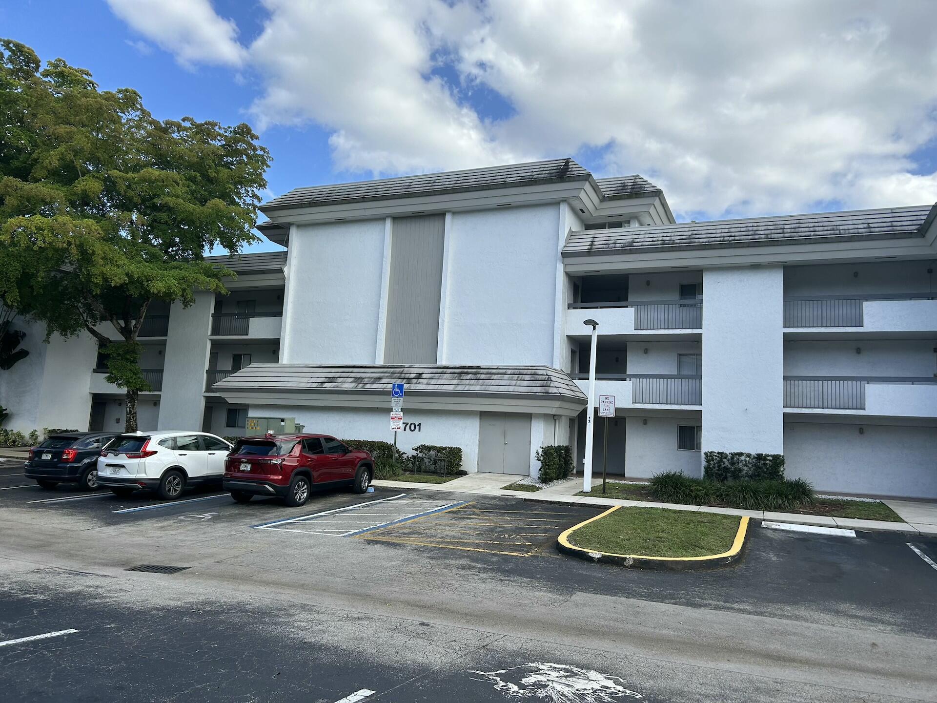 701 North Pine Island Road, Unit 304 Plantation, FL 33324 - Photo 68 of 77 a car parked in front of a building