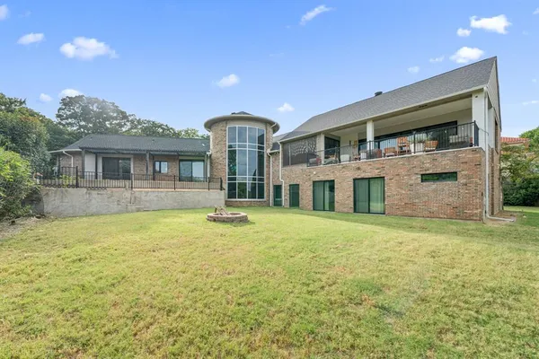 a front view of a house with yard and balcony