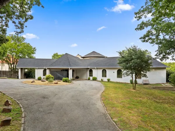 a house view with a sitting space and garden