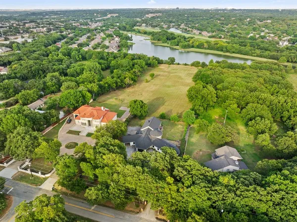 an aerial view of residential houses with outdoor space and river