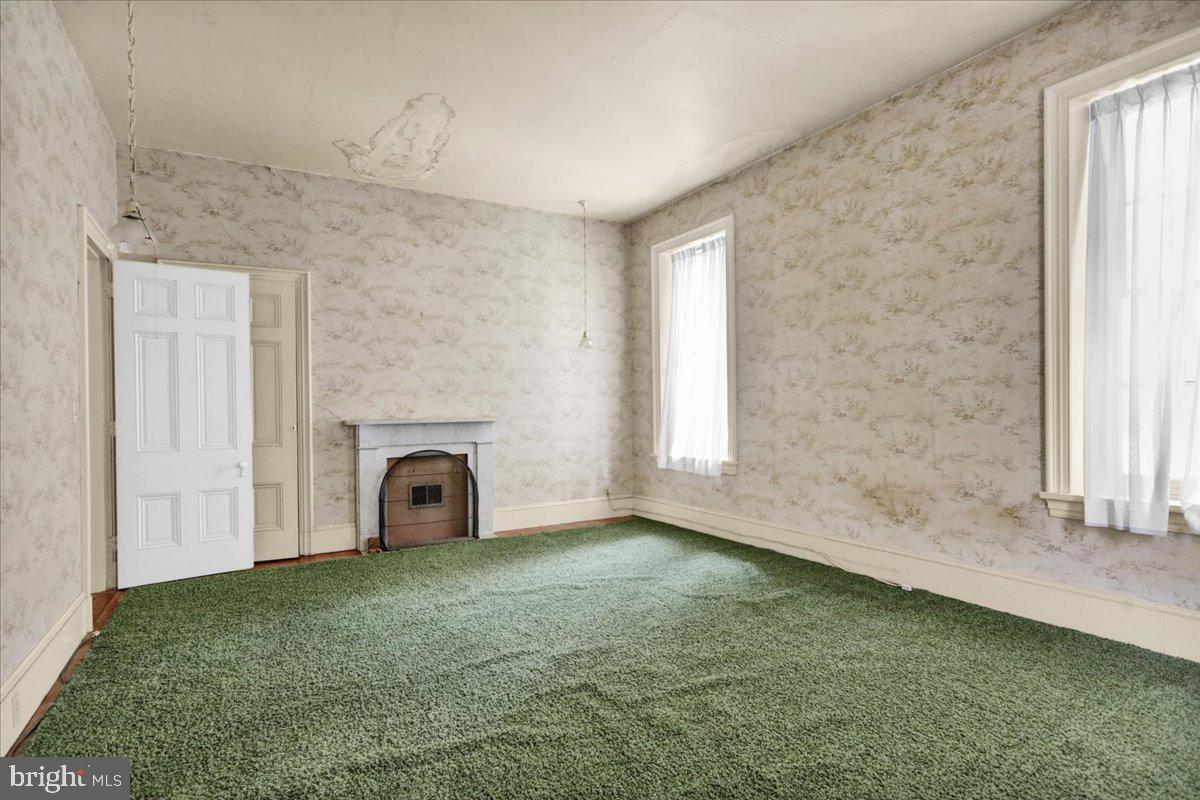 1670 Moselem Spring Road Hamburg, PA 19526 - Photo 11 of 78 a view of an empty room with a fireplace and a window