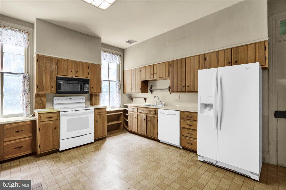 1670 Moselem Spring Road Hamburg, PA 19526 - Photo 15 of 78 a kitchen with white cabinets and white appliances