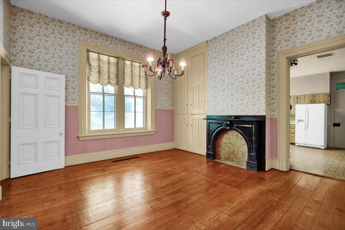 1670 Moselem Spring Road Hamburg, PA 19526 - Photo 25 of 78 a view of empty room with fireplace and wooden floor