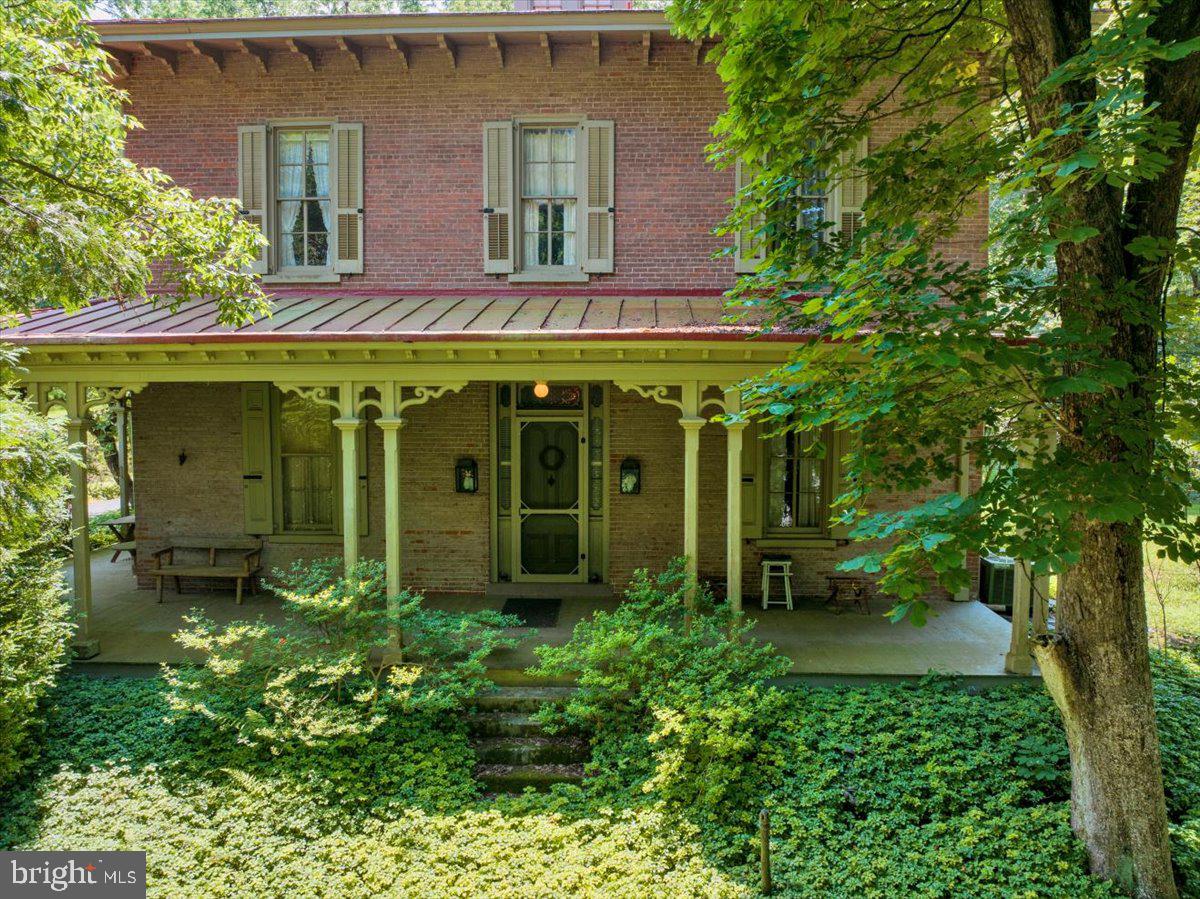 1670 Moselem Spring Road Hamburg, PA 19526 - Photo 60 of 78 a view of a house with potted plants and a large tree