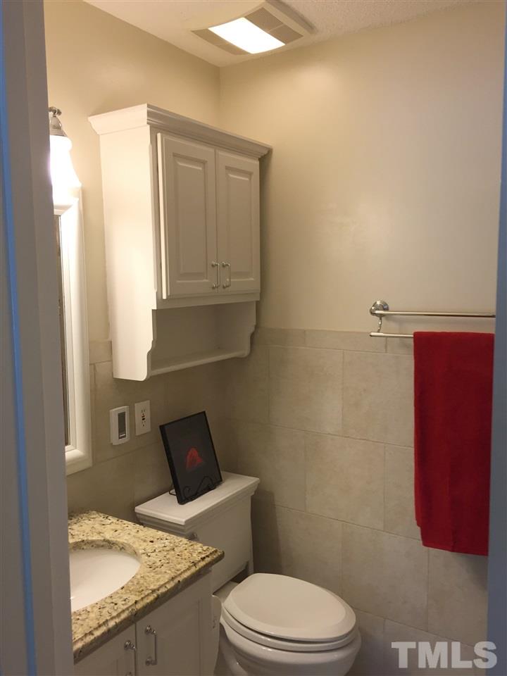 134 Timber Ridge Drive Durham, NC 27713 - Photo 19 of 25 Spa-like in design, the Master Bathroom has heat controlled tile flooring, designer tile bench seating in the glass doored shower, and granite topped vanity.