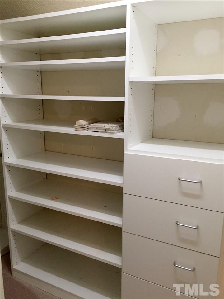 134 Timber Ridge Drive Durham, NC 27713 - Photo 22 of 25 Custom built in shelving maximize the space in the Master walk-in Closet.