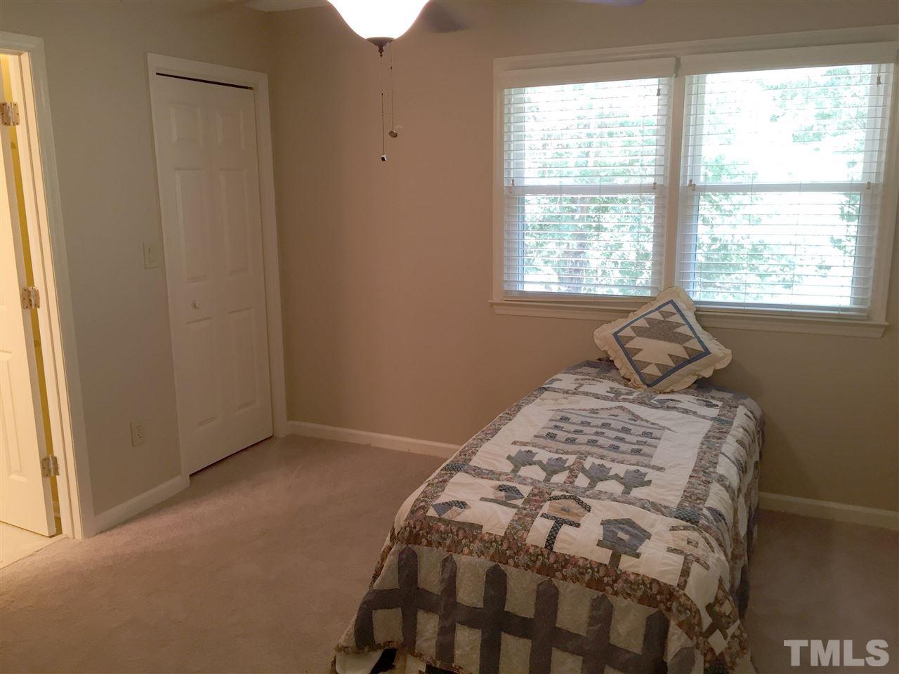134 Timber Ridge Drive Durham, NC 27713 - Photo 23 of 25 Roomy second bedroom has great light, remote controlled lighted ceiling fan and generous walk in closet.