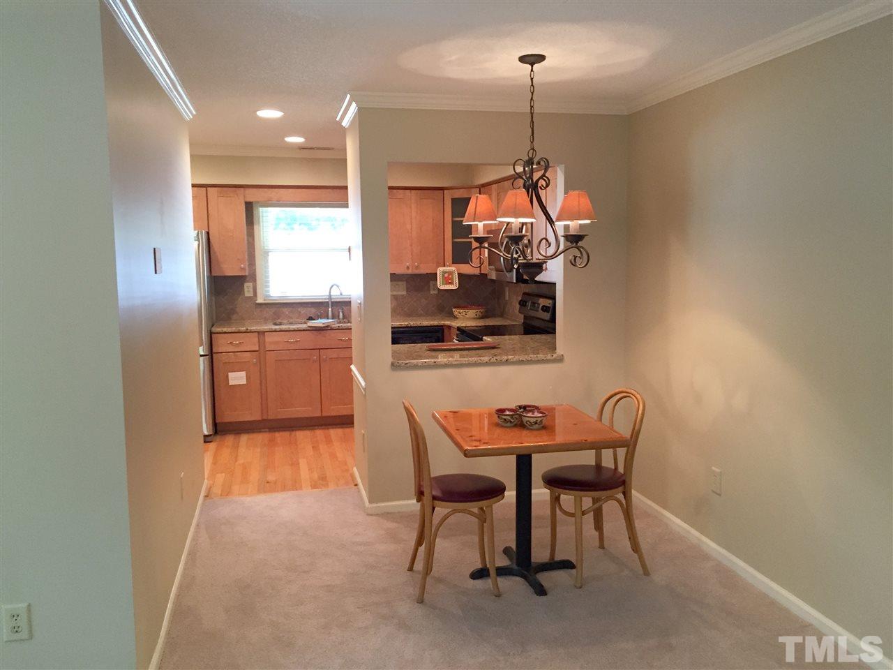 134 Timber Ridge Drive Durham, NC 27713 - Photo 10 of 25 Designer lighting throughout home. Convenient pass through from Kitchen to Dining Area, situated adjacent to open Living Room.