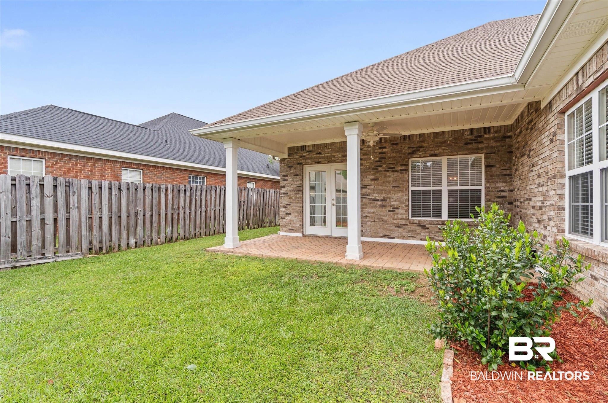 1003 Weatherby Street South Saraland, AL 36571 - Photo 30 of 31 Fenced yard with french doors and a patio