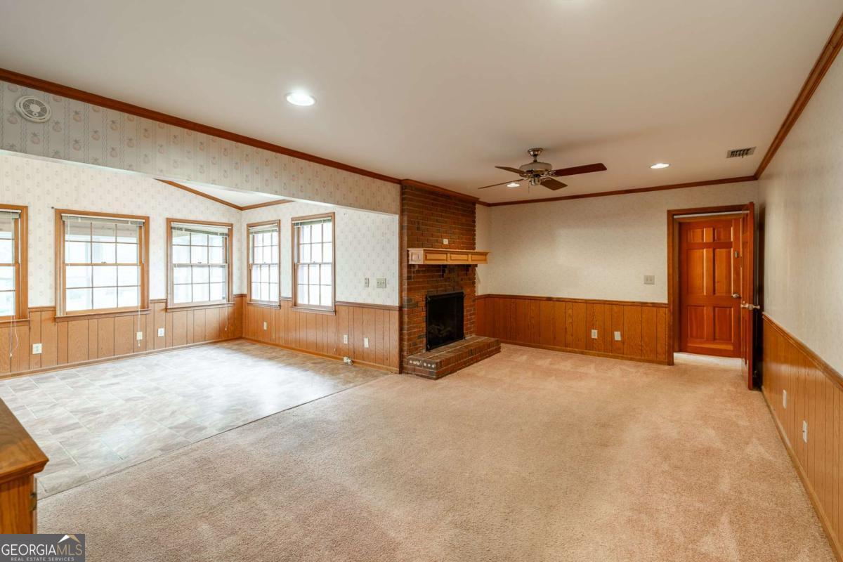 389 Ashton Drive Athens, GA 30606 - Photo 18 of 72 a view of an empty room with a fireplace and a window