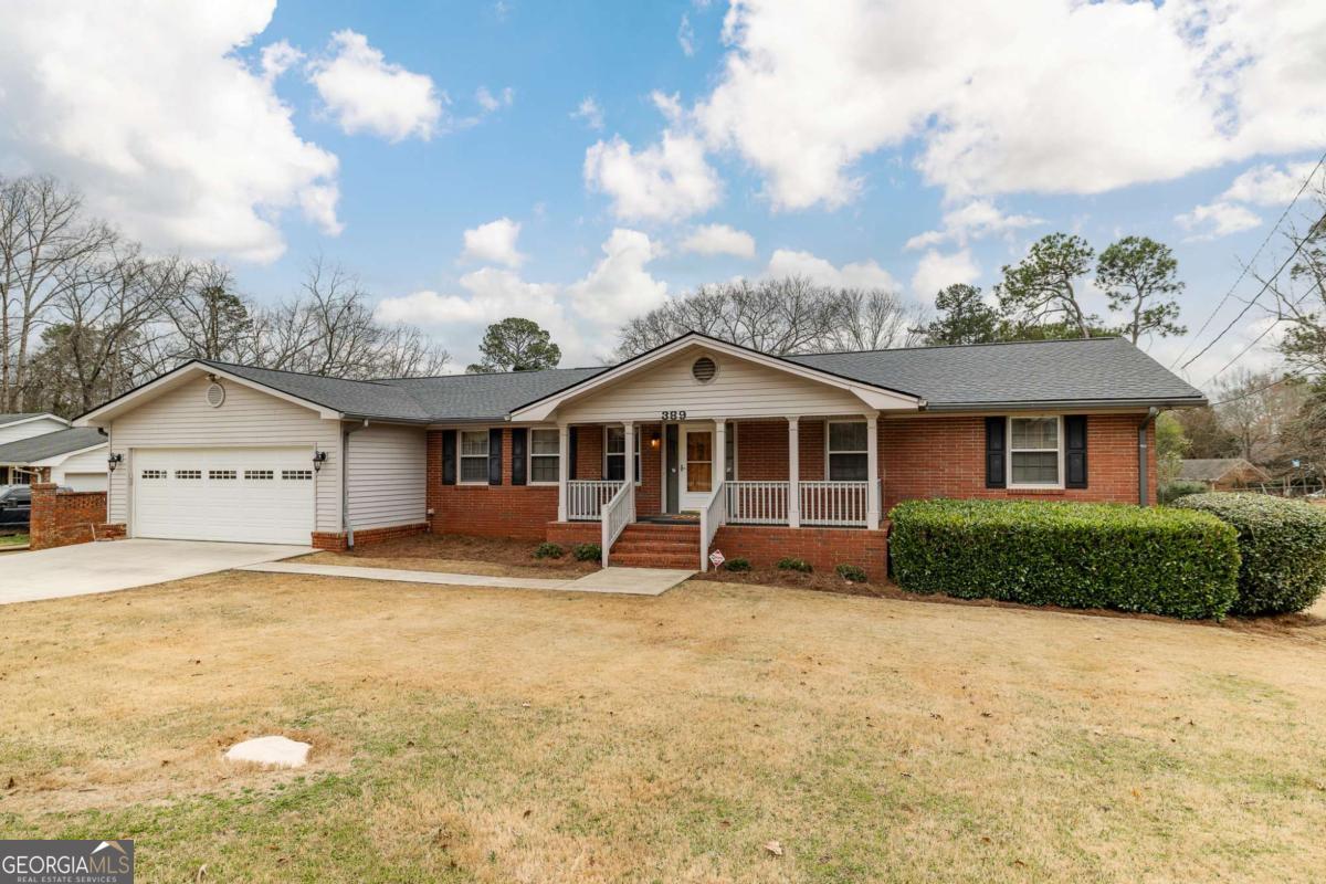 389 Ashton Drive Athens, GA 30606 - Photo 2 of 72 a front view of a house with a yard and garage