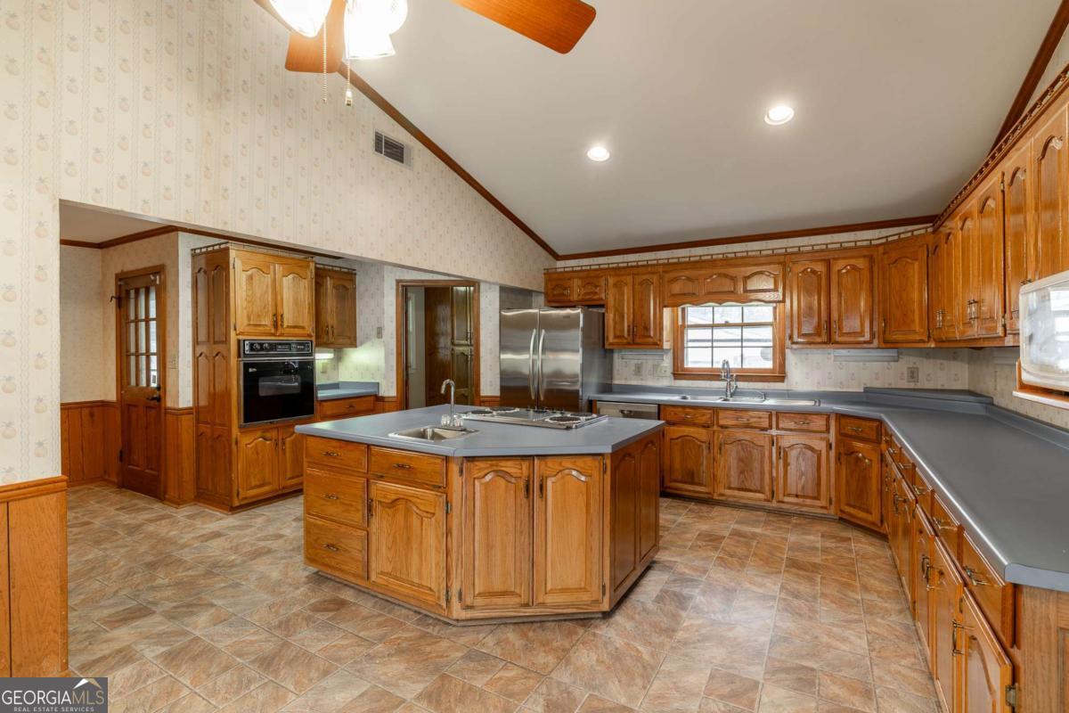 389 Ashton Drive Athens, GA 30606 - Photo 24 of 72 a kitchen with stainless steel appliances granite countertop a stove a sink dishwasher and a refrigerator