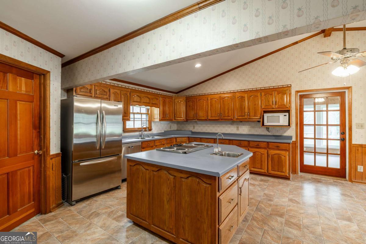 389 Ashton Drive Athens, GA 30606 - Photo 25 of 72 a kitchen with stainless steel appliances granite countertop sink stove and refrigerator