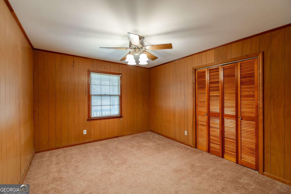 389 Ashton Drive Athens, GA 30606 - Photo 36 of 72 an empty room with chandelier fan and windows
