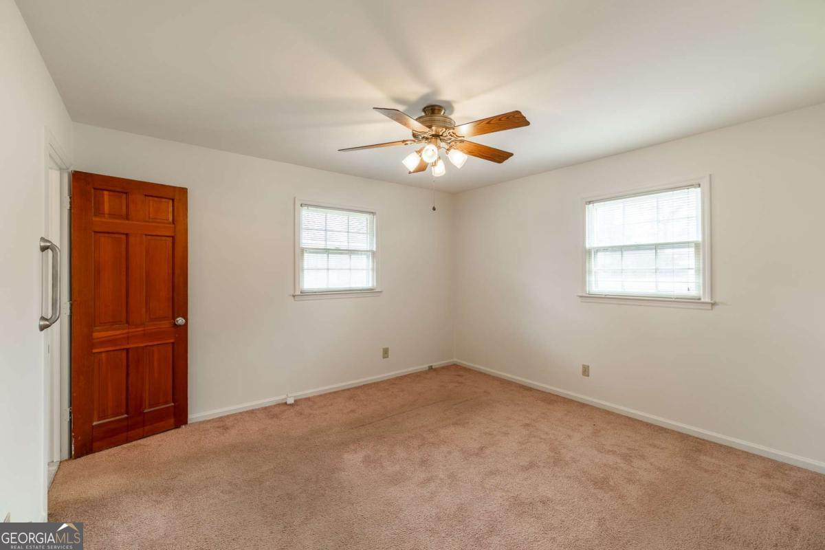 389 Ashton Drive Athens, GA 30606 - Photo 40 of 72 an empty room with windows and fan
