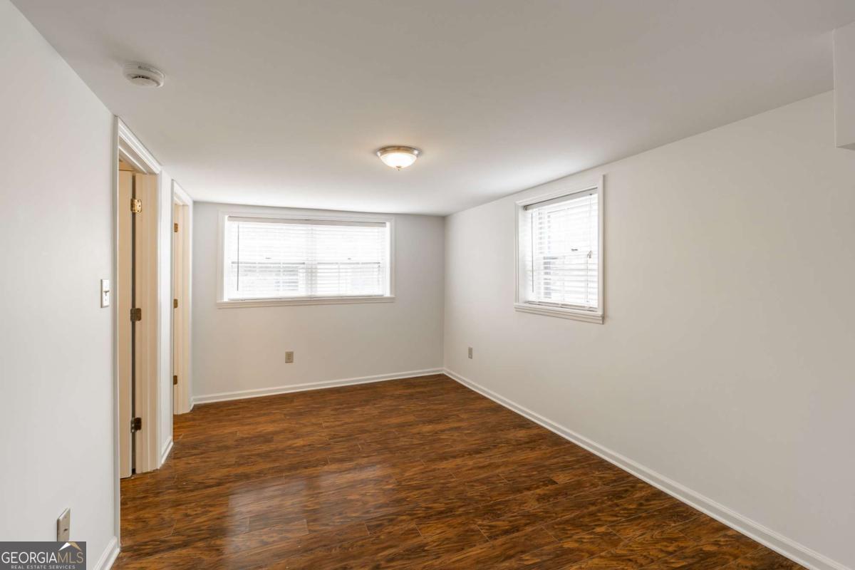 389 Ashton Drive Athens, GA 30606 - Photo 50 of 72 an empty room with wooden floor and windows
