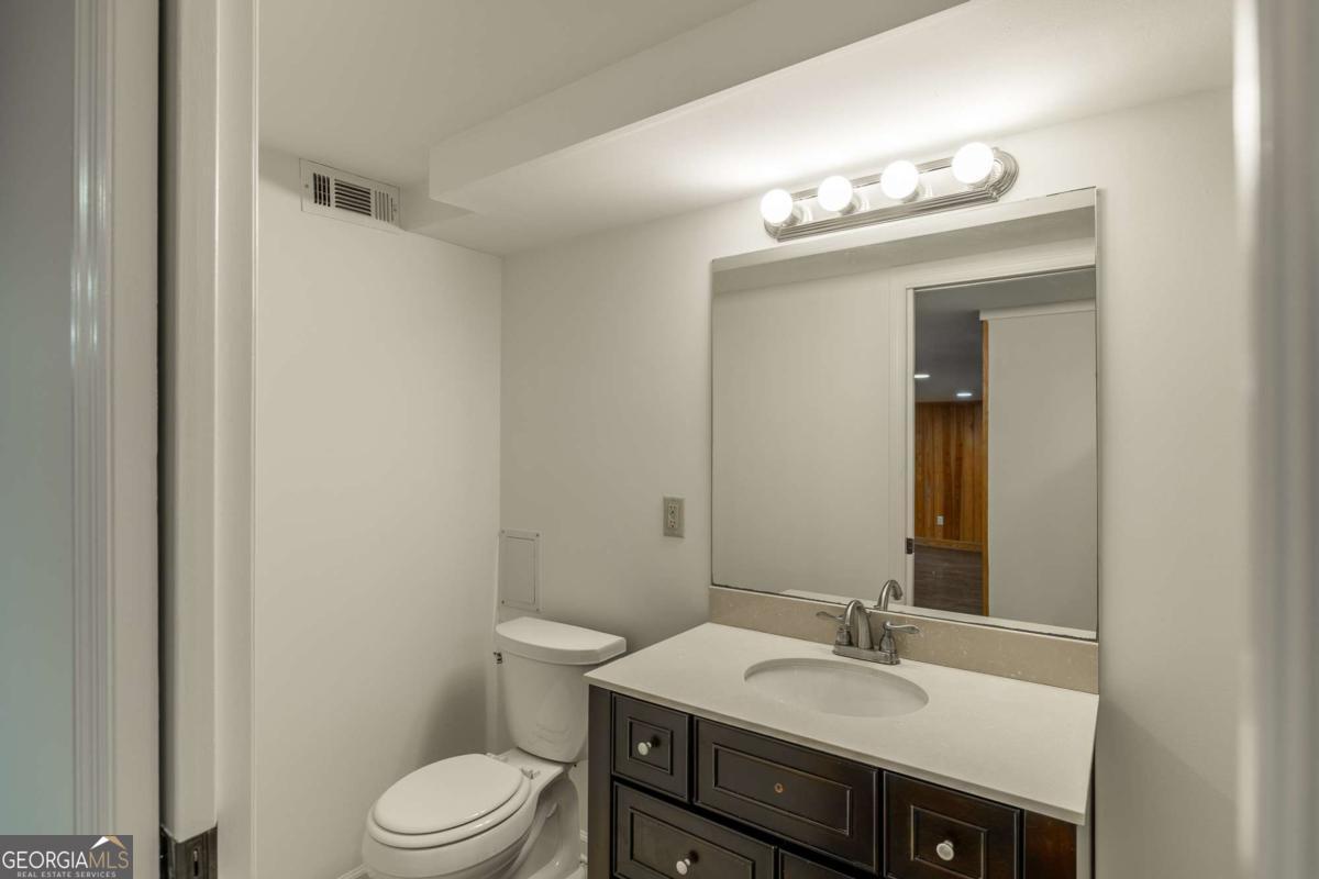 389 Ashton Drive Athens, GA 30606 - Photo 60 of 72 a bathroom with a sink vanity mirror and toilet