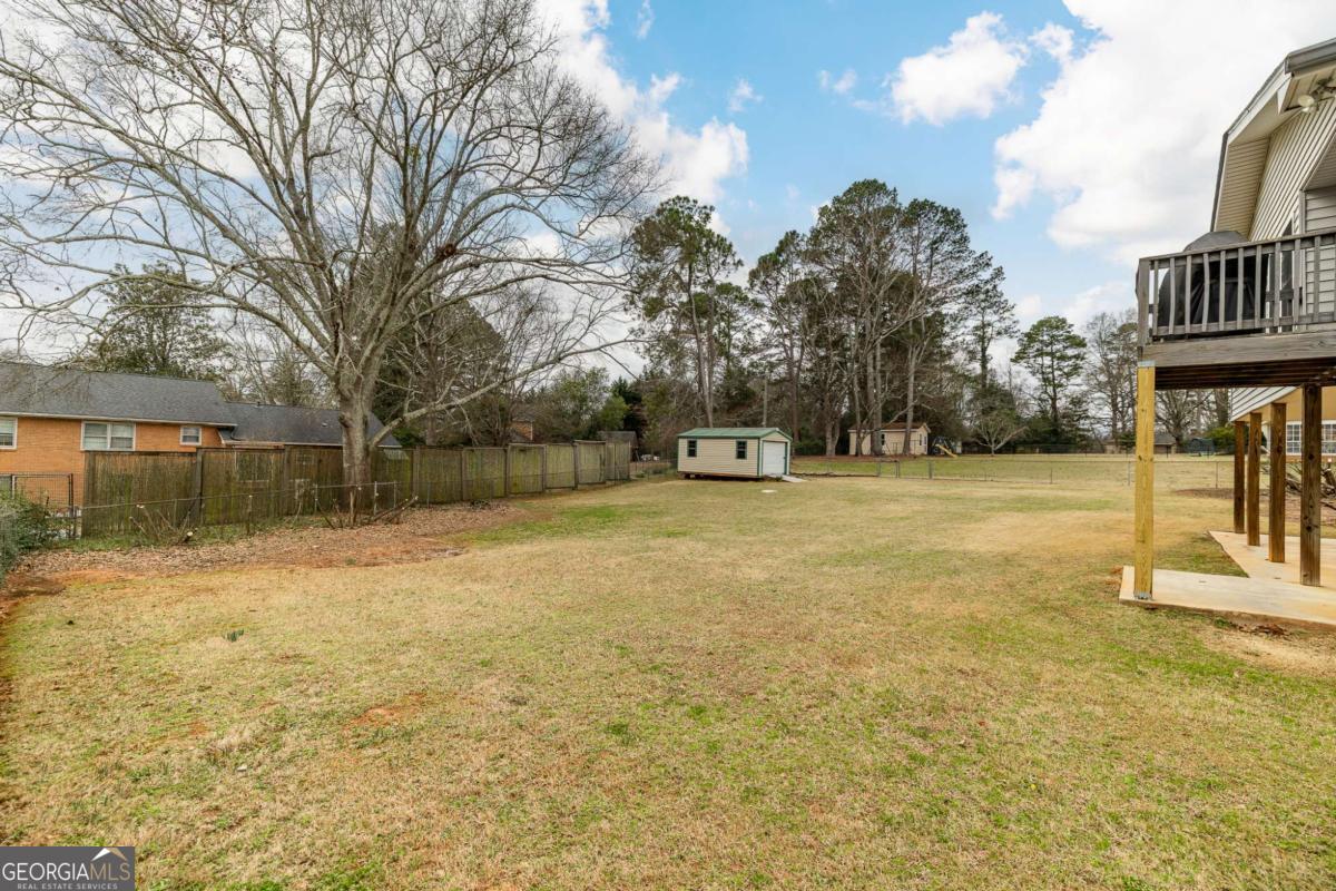 389 Ashton Drive Athens, GA 30606 - Photo 67 of 72 a front view of a house with a yard and garage
