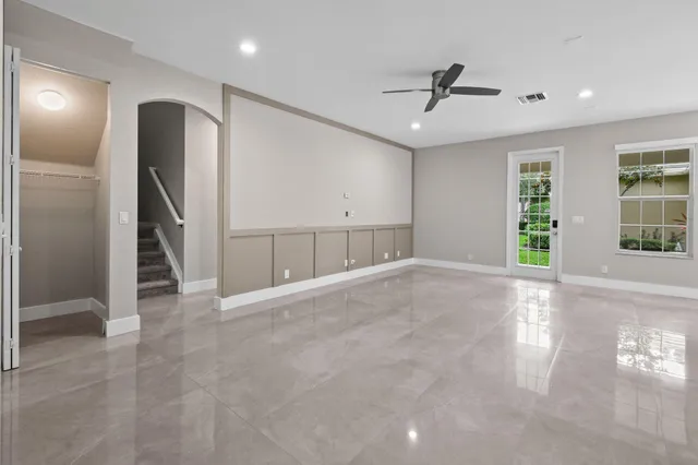 a white toilet sitting next to a bath tub