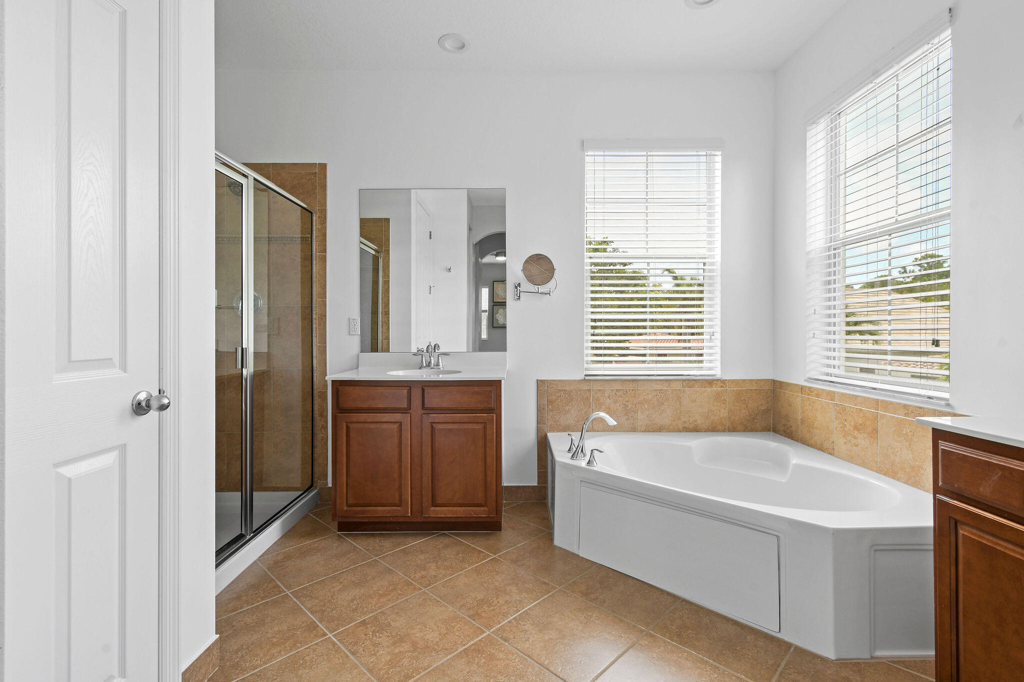 111 Tullamore Avenue Jupiter, FL 33458 - Photo 44 of 64 a bathroom with a tub a sink and a window