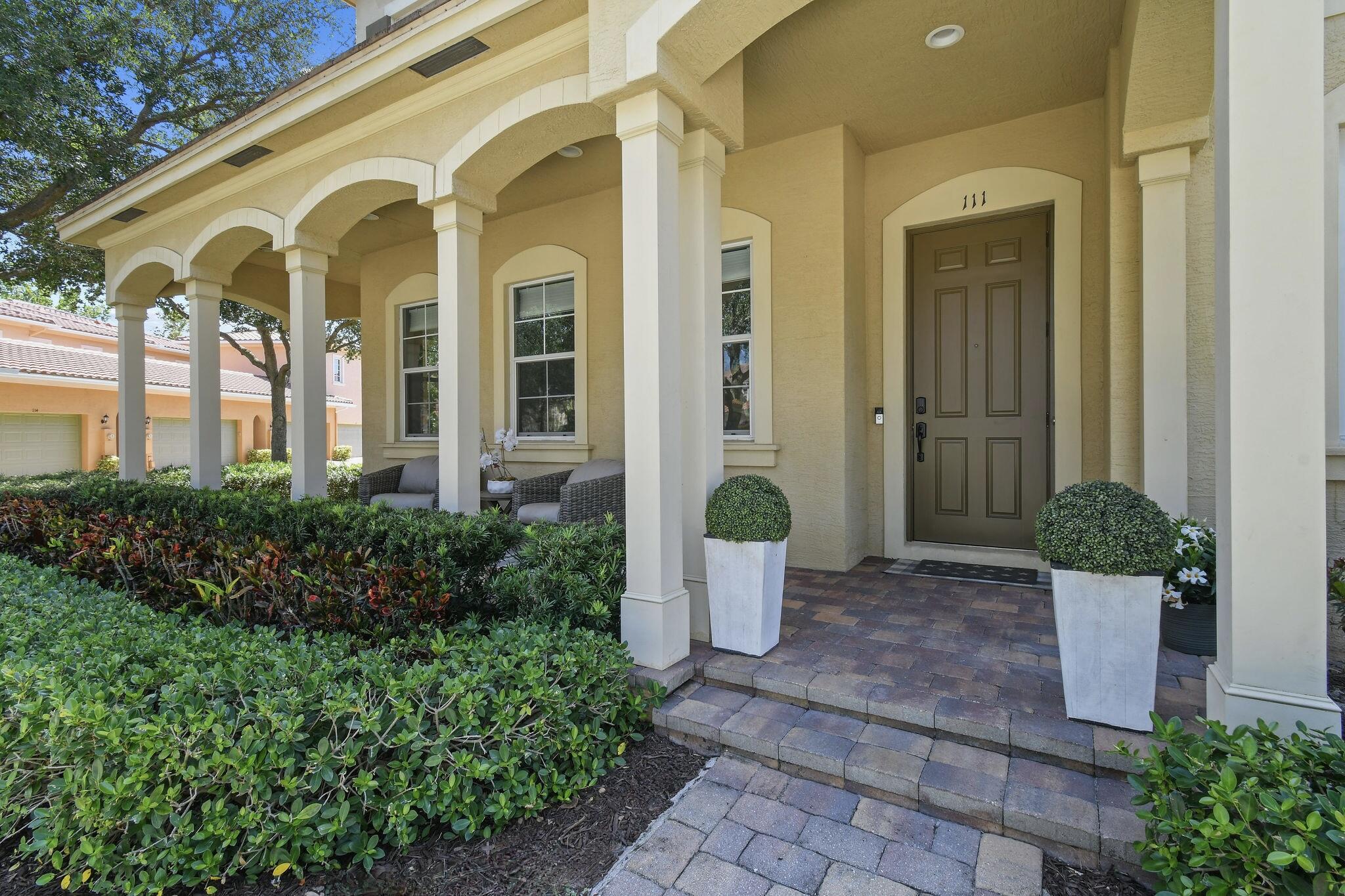 111 Tullamore Avenue Jupiter, FL 33458 - Photo 5 of 64 a front view of a house with garden