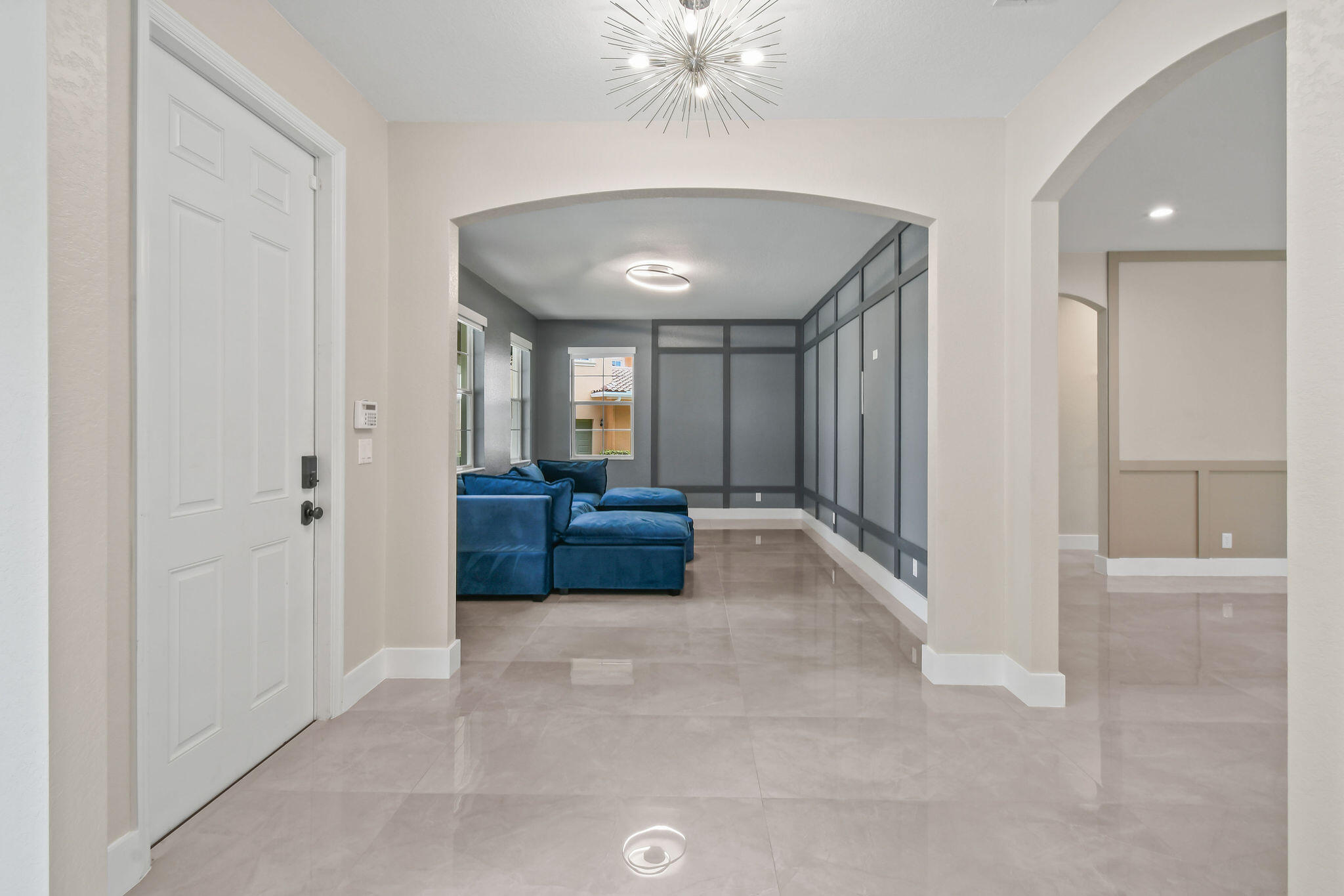 111 Tullamore Avenue Jupiter, FL 33458 - Photo 7 of 64 a living room with furniture and a chandelier