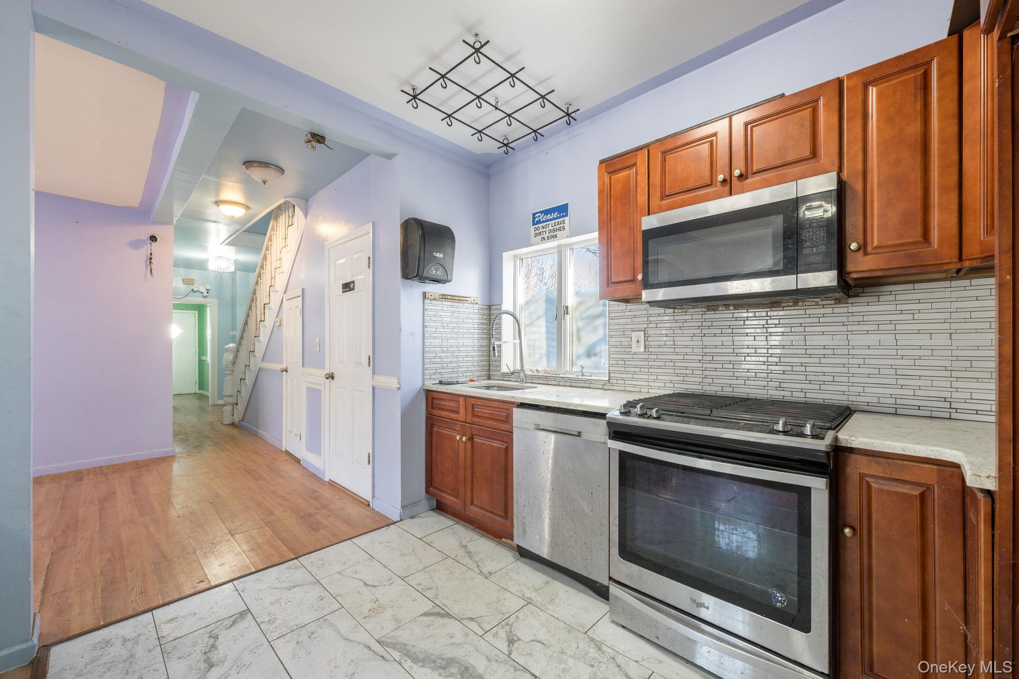 2214 Hermany Avenue Bronx, NY 10473 - Photo 16 of 43 a kitchen with stainless steel appliances granite countertop a stove microwave and refrigerator