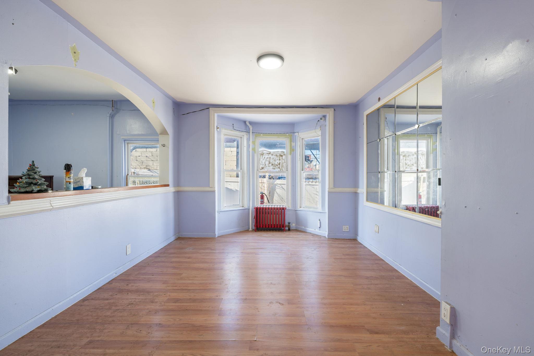 2214 Hermany Avenue Bronx, NY 10473 - Photo 21 of 43 a view of an empty room with a window and wooden floor