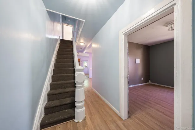 a view of an entryway with wooden floor