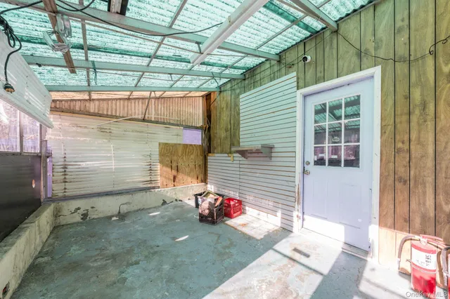 a view of a porch with a table and chairs and potted plants