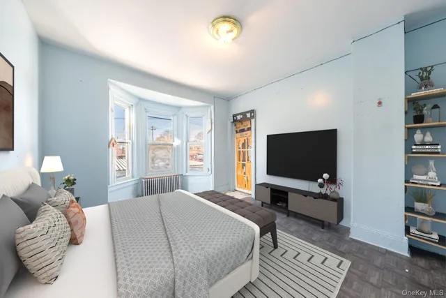 a bedroom with a bed and a television