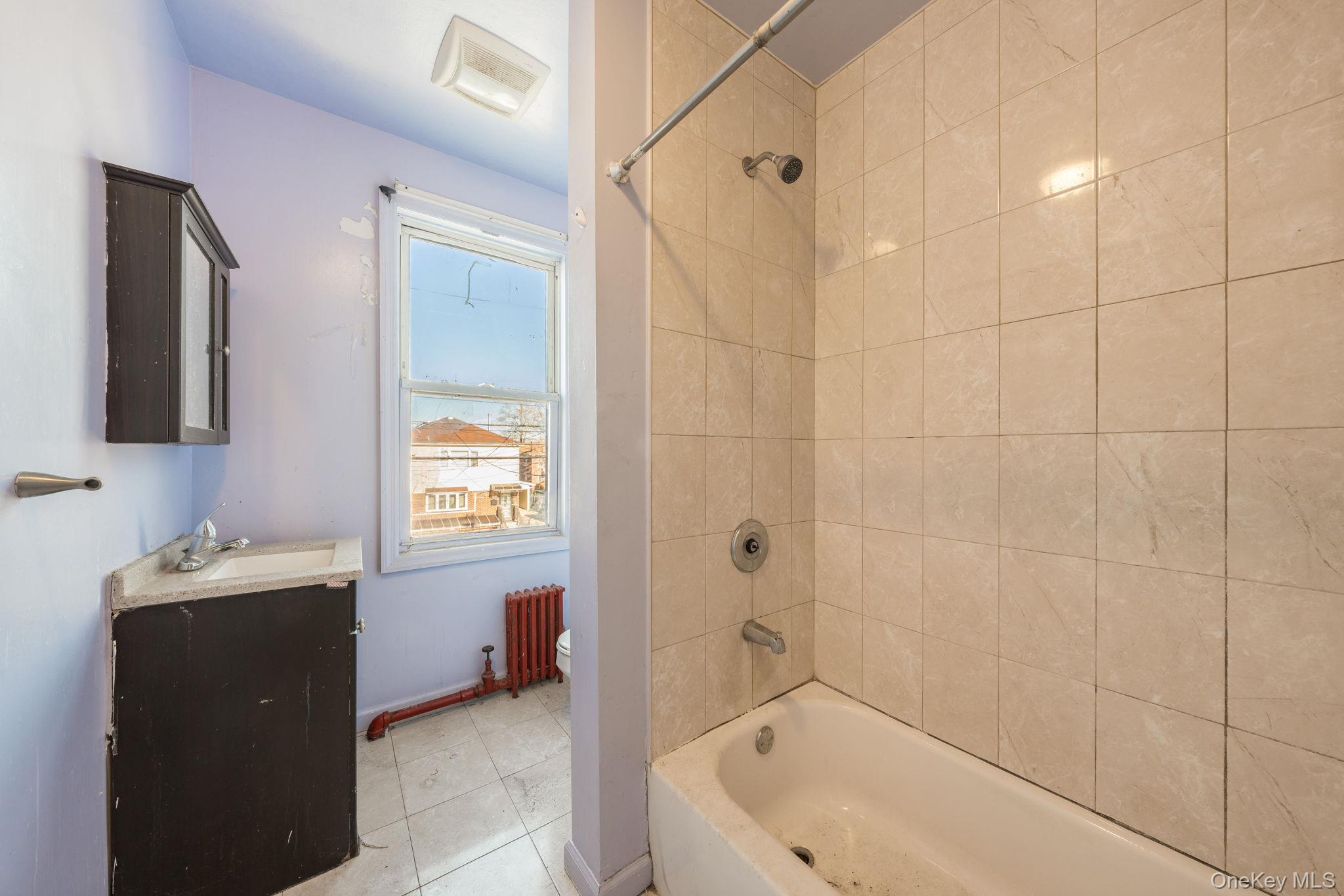 2214 Hermany Avenue Bronx, NY 10473 - Photo 9 of 43 a bathroom with a sink a toilet and shower