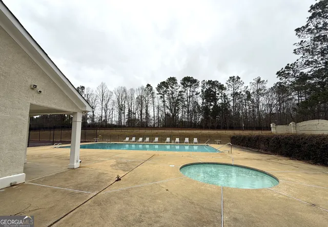 a swimming pool with outdoor seating and yard