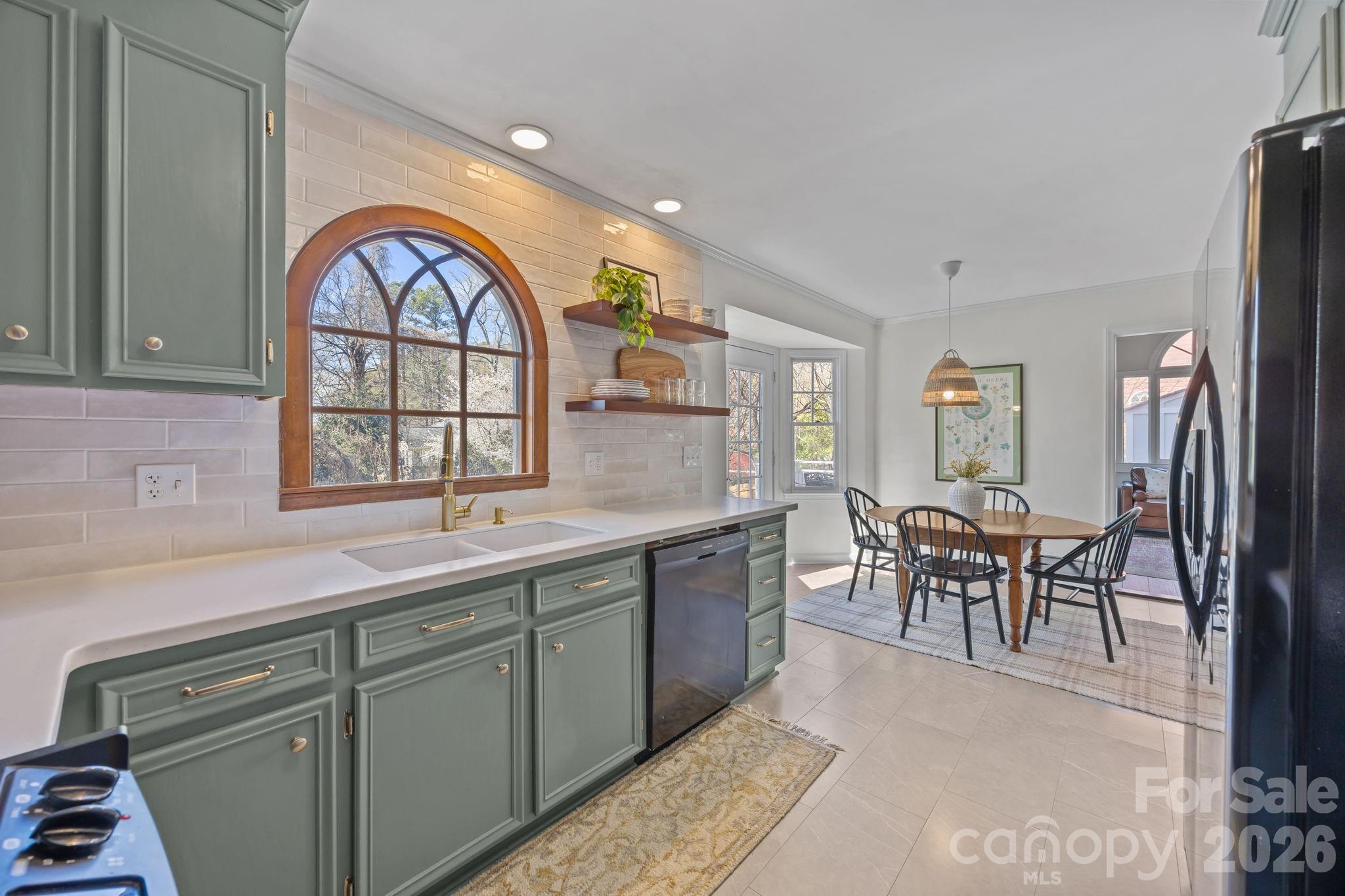264 Post Oak Avenue Southwest Concord, NC 28025 - Photo 11 of 39 a kitchen with stainless steel appliances granite countertop a sink a stove and a dining table