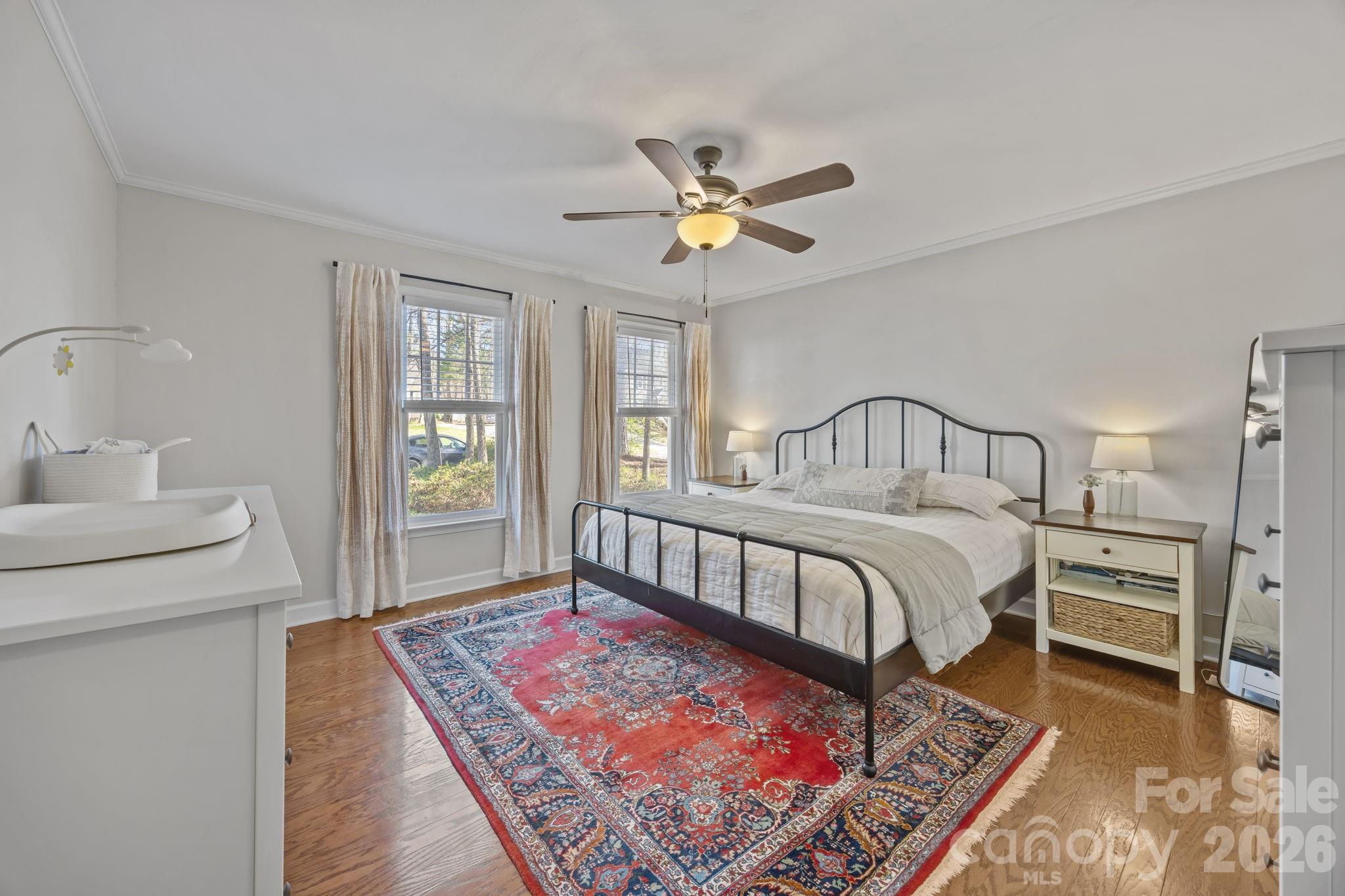 264 Post Oak Avenue Southwest Concord, NC 28025 - Photo 18 of 39 a bedroom with a bed a chandelier and dresser