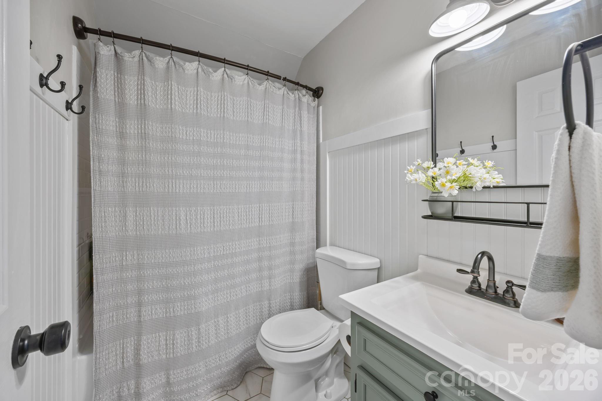 264 Post Oak Avenue Southwest Concord, NC 28025 - Photo 28 of 39 a bathroom with a granite countertop sink a toilet and a mirror